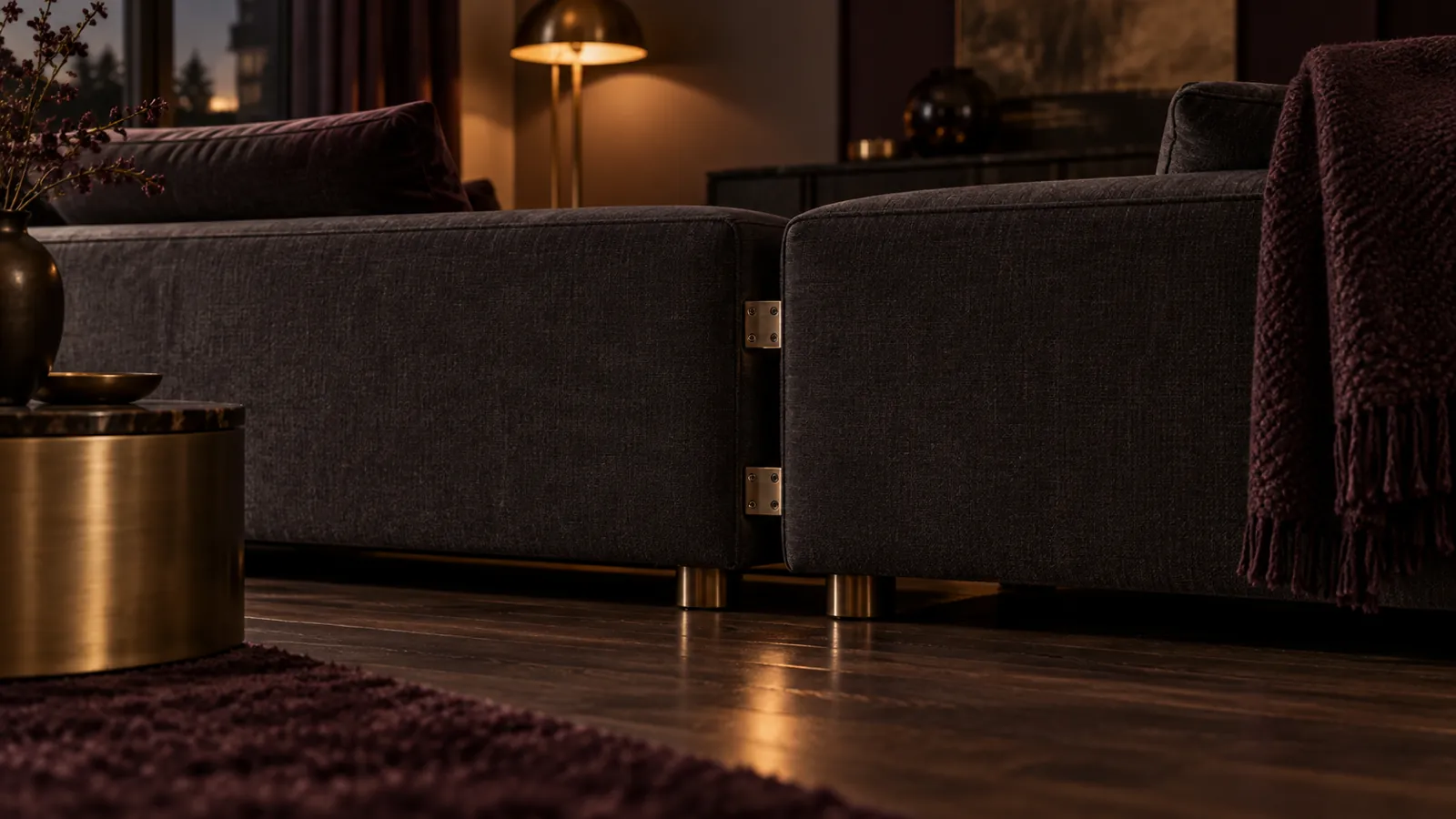 Close view of connectors beneath charcoal modular sofa sections