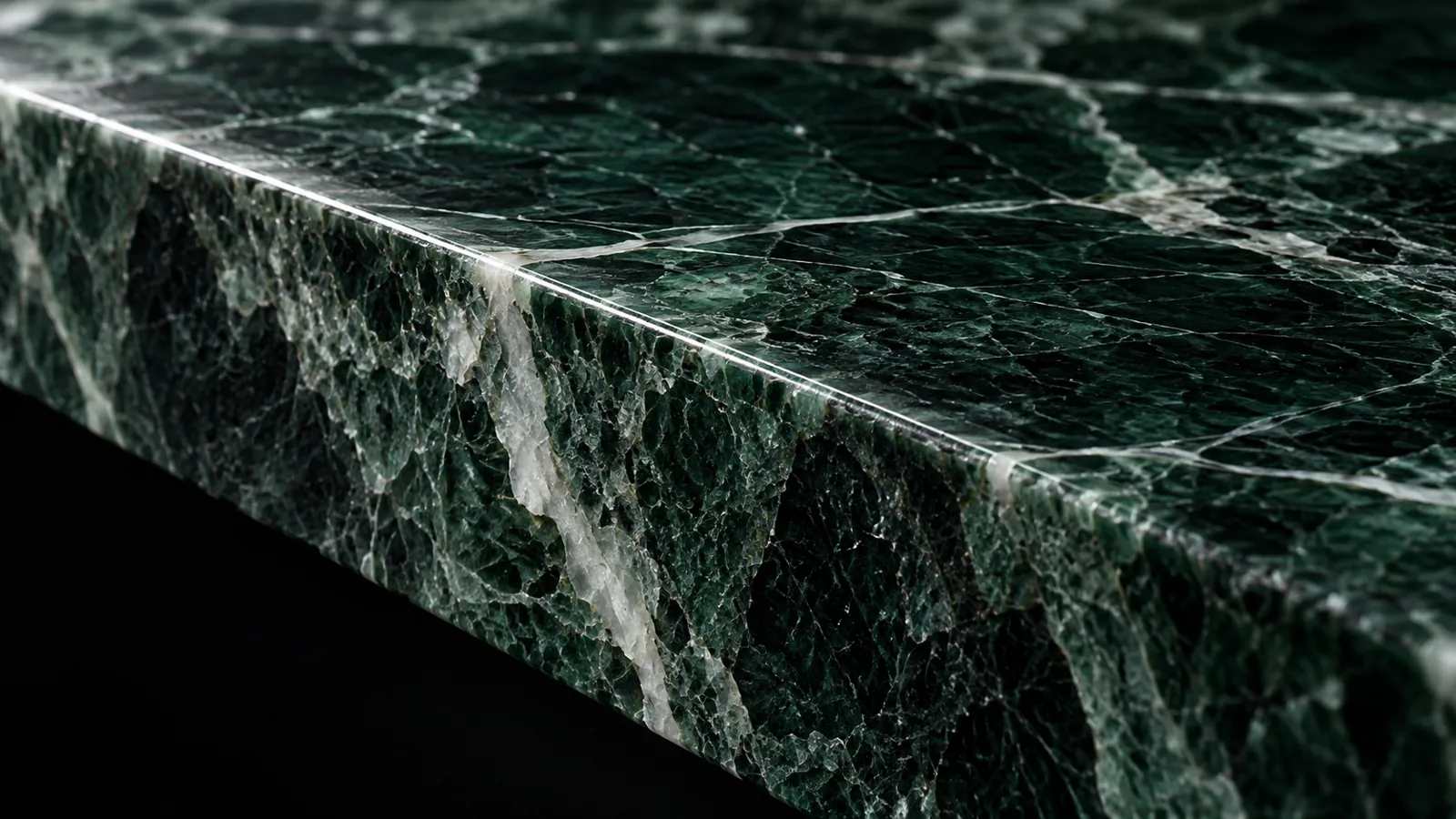 Illustrative close-up of a dark green marble slab edge and natural veining