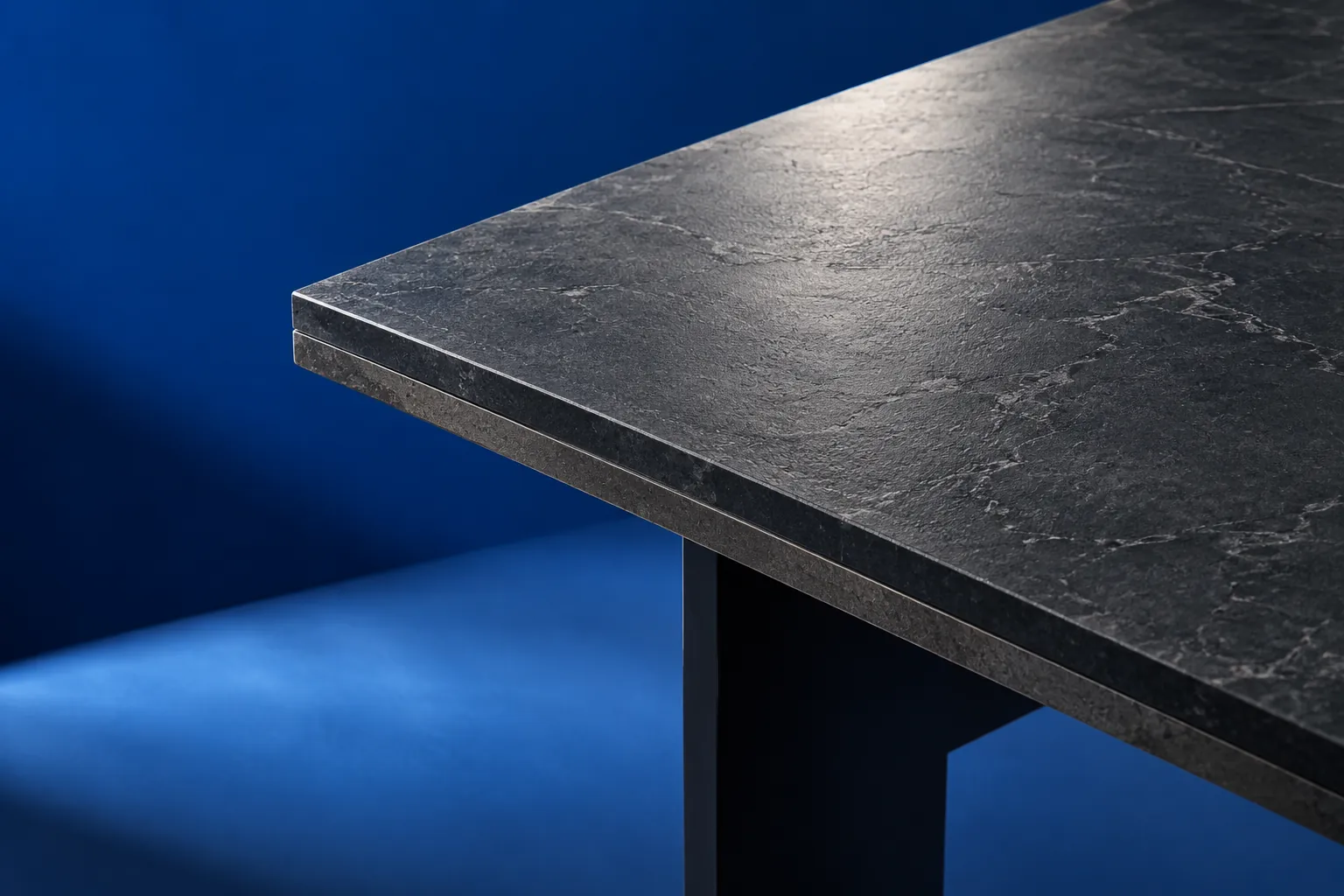 Close view of a dark ceramic tabletop corner and layered edge