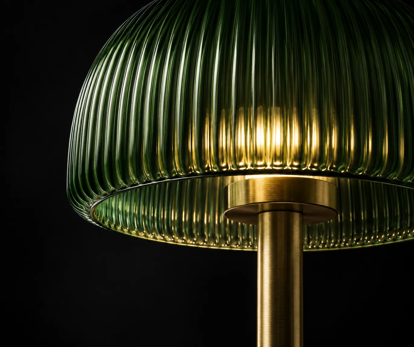 Concept illustration: Green ribbed glass shade and brass stem in a dark studio