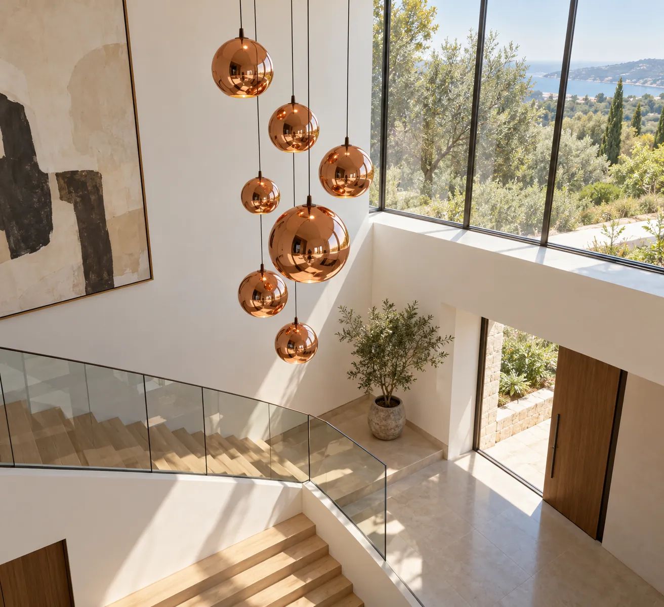 Copper sphere pendants suspended in a bright double-height stairwell