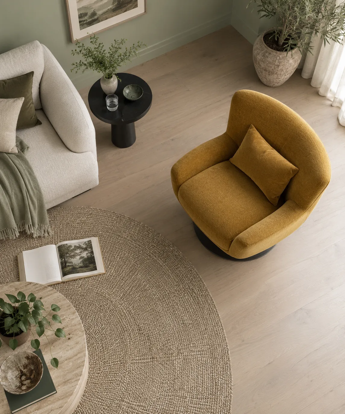Overhead view of a mustard armchair beside a pale sofa and round rug